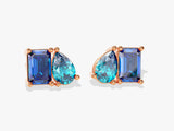 Rose gold earrings with emerald and pear-shaped blue gemstones