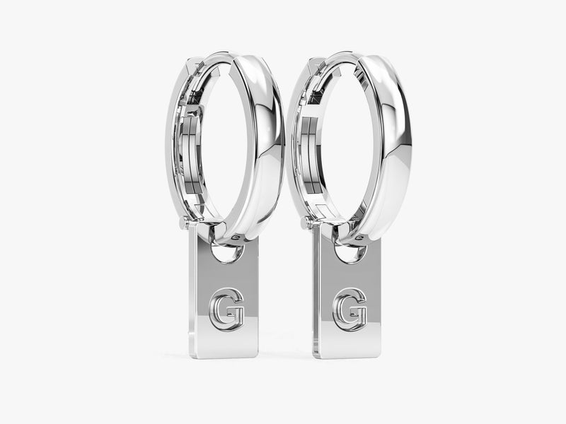 Silver hoop earrings with dangling 'G' initial charms