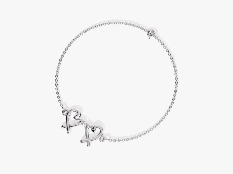 Silver bracelet with double heart charm and diamond accent