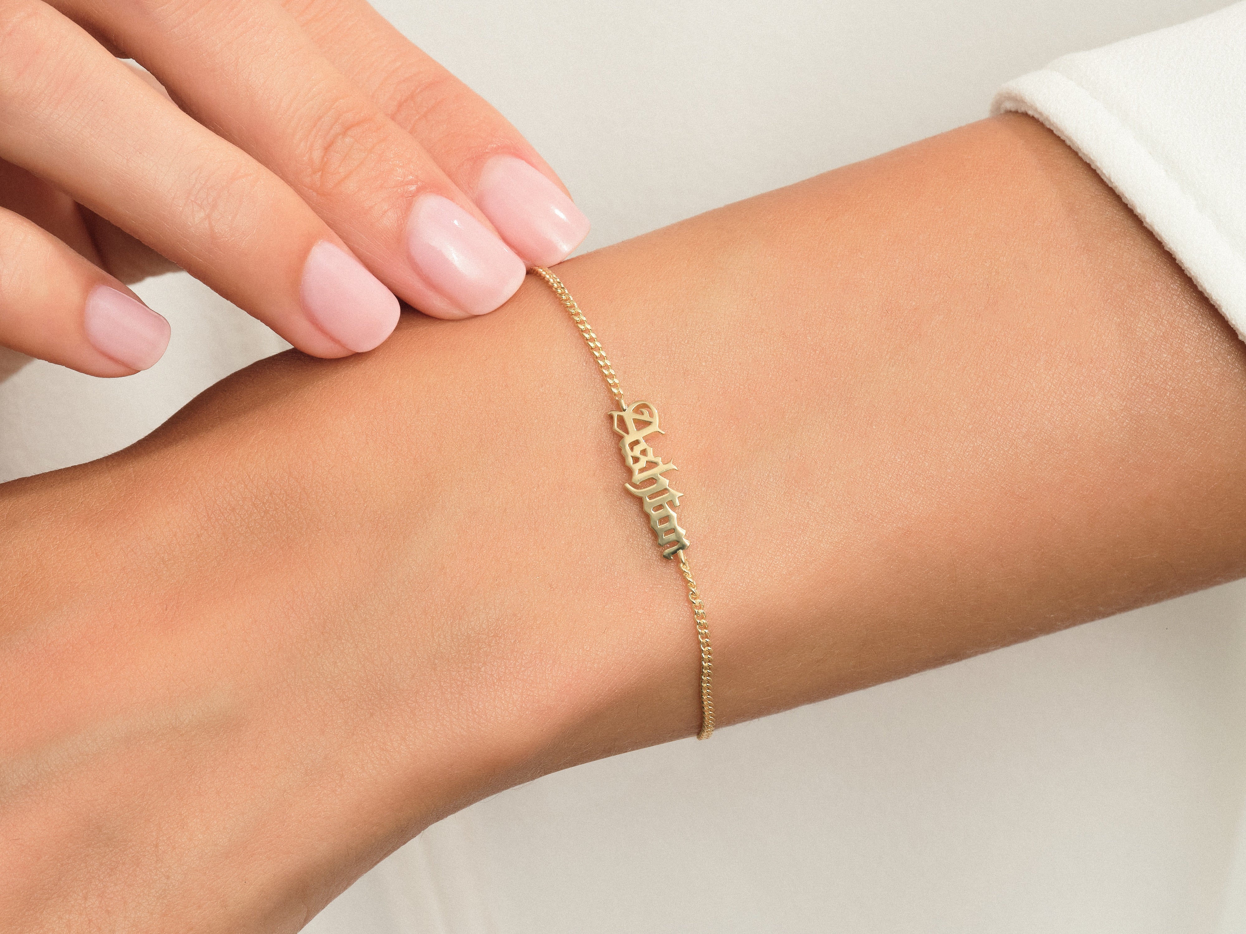 Gold name bracelet on wrist, personalized jewelry gift