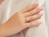 Gold oval diamond ring on a woman's finger, jewelry