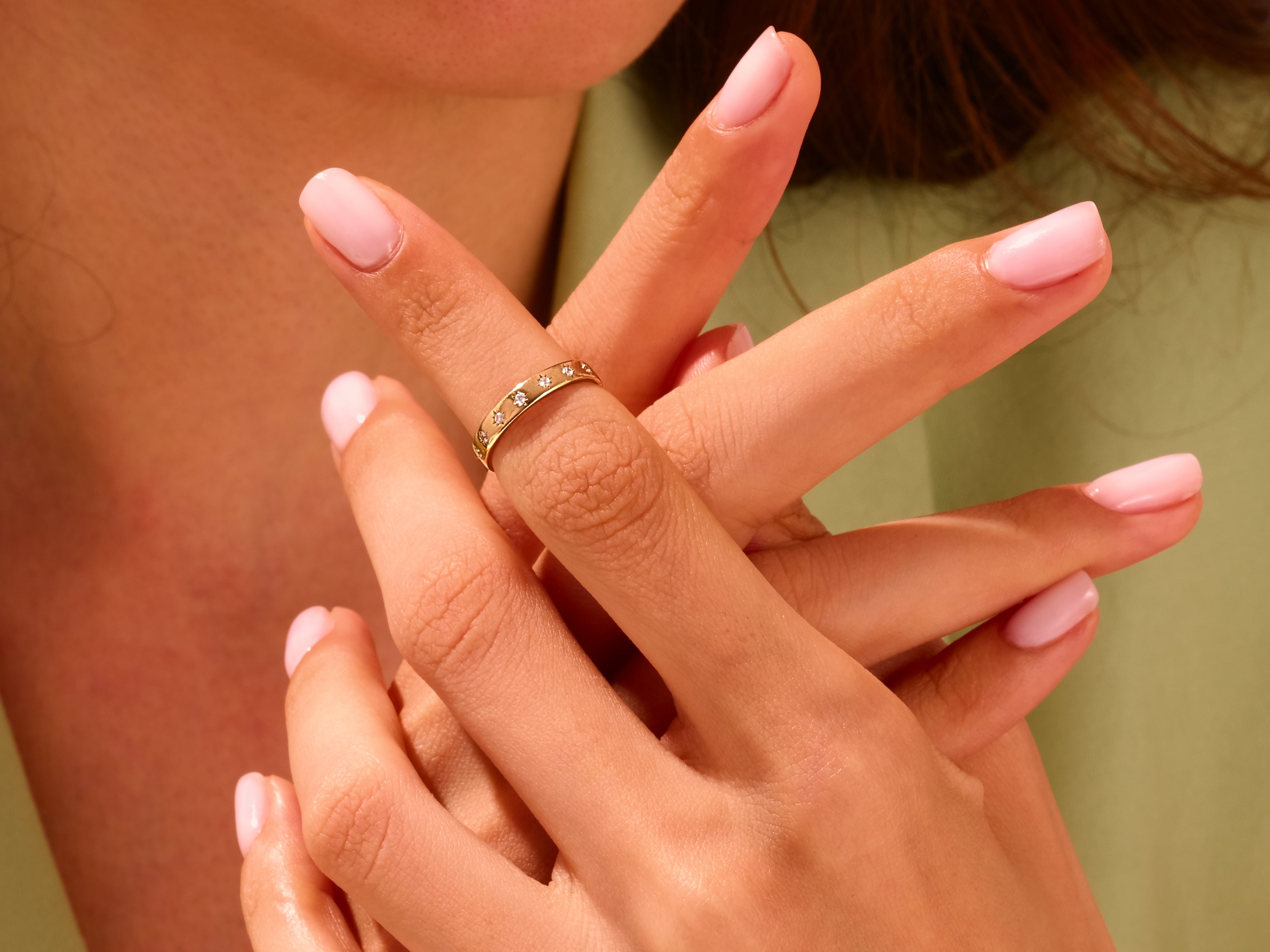Gold diamond ring on a woman's finger, elegant jewelry for sale
