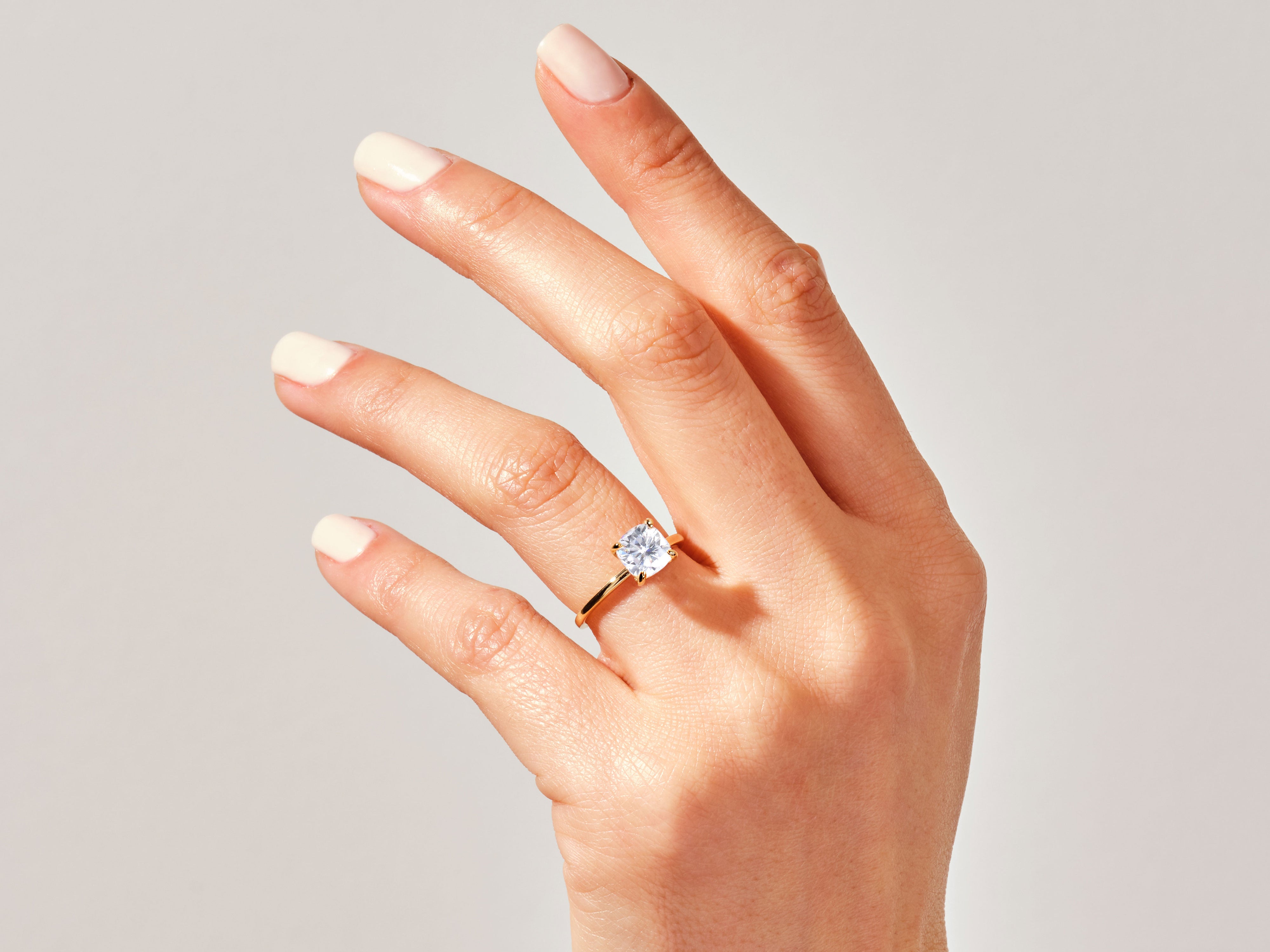 Diamond engagement ring on a hand, fine jewelry