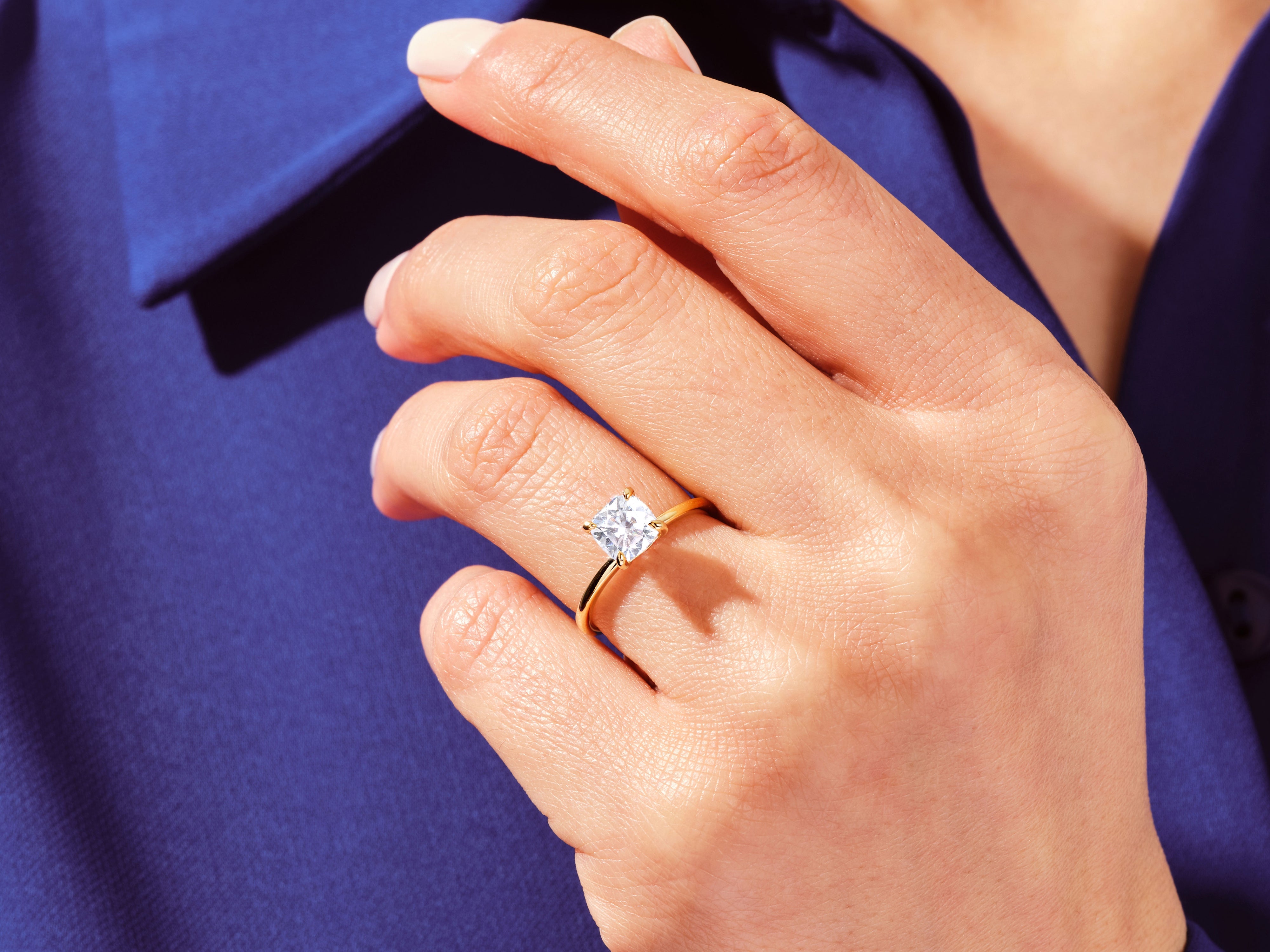 Gold ring with square diamond on hand, jewelry product shot