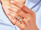Gold rings with emerald-cut diamonds on a woman's hand