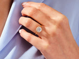 Gold diamond halo ring on a woman's hand