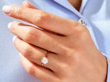 Gold bezel set diamond ring on a woman's hand