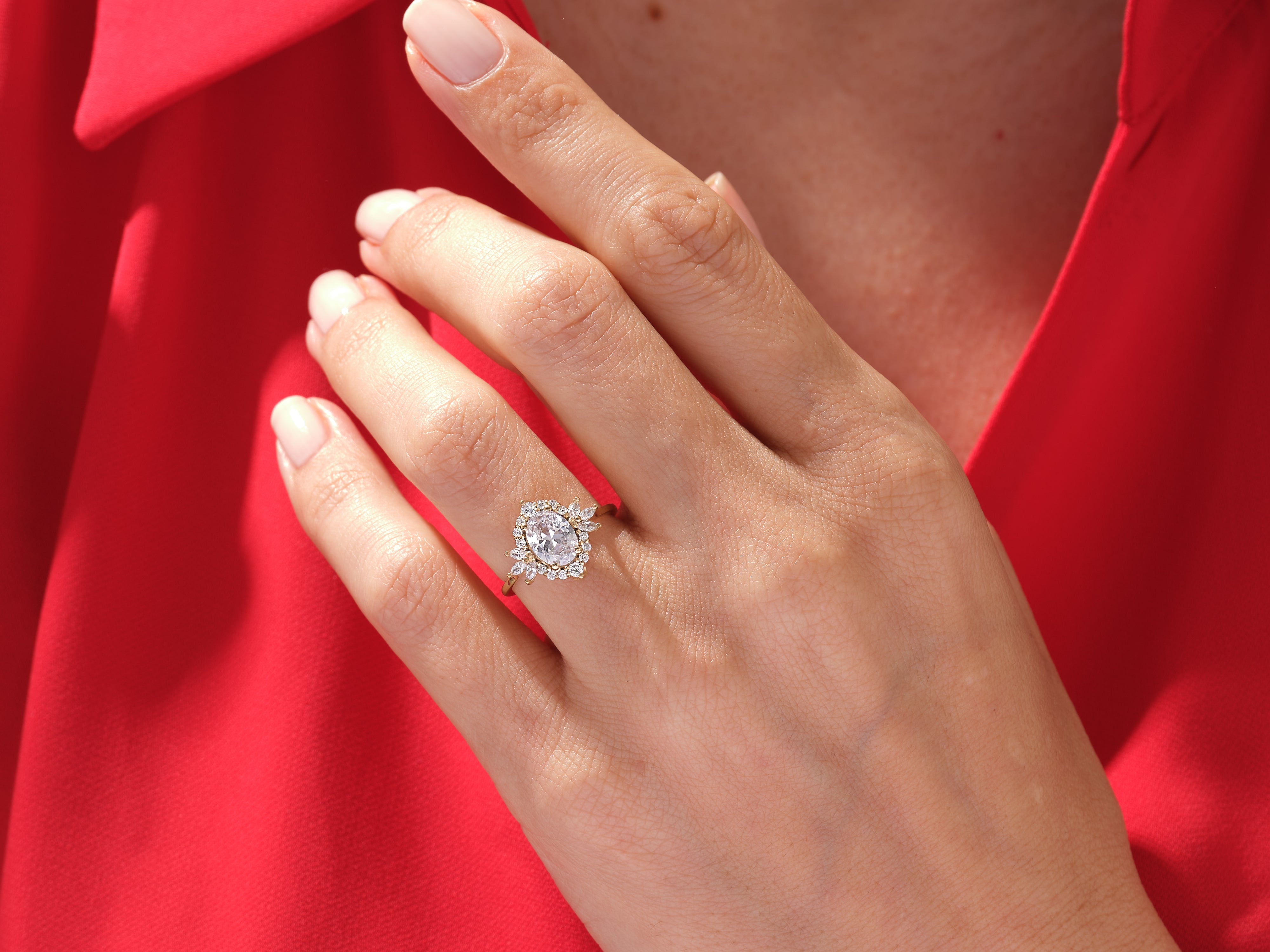 Oval diamond halo ring on a hand, jewelry