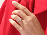 Oval diamond halo ring on a hand, jewelry