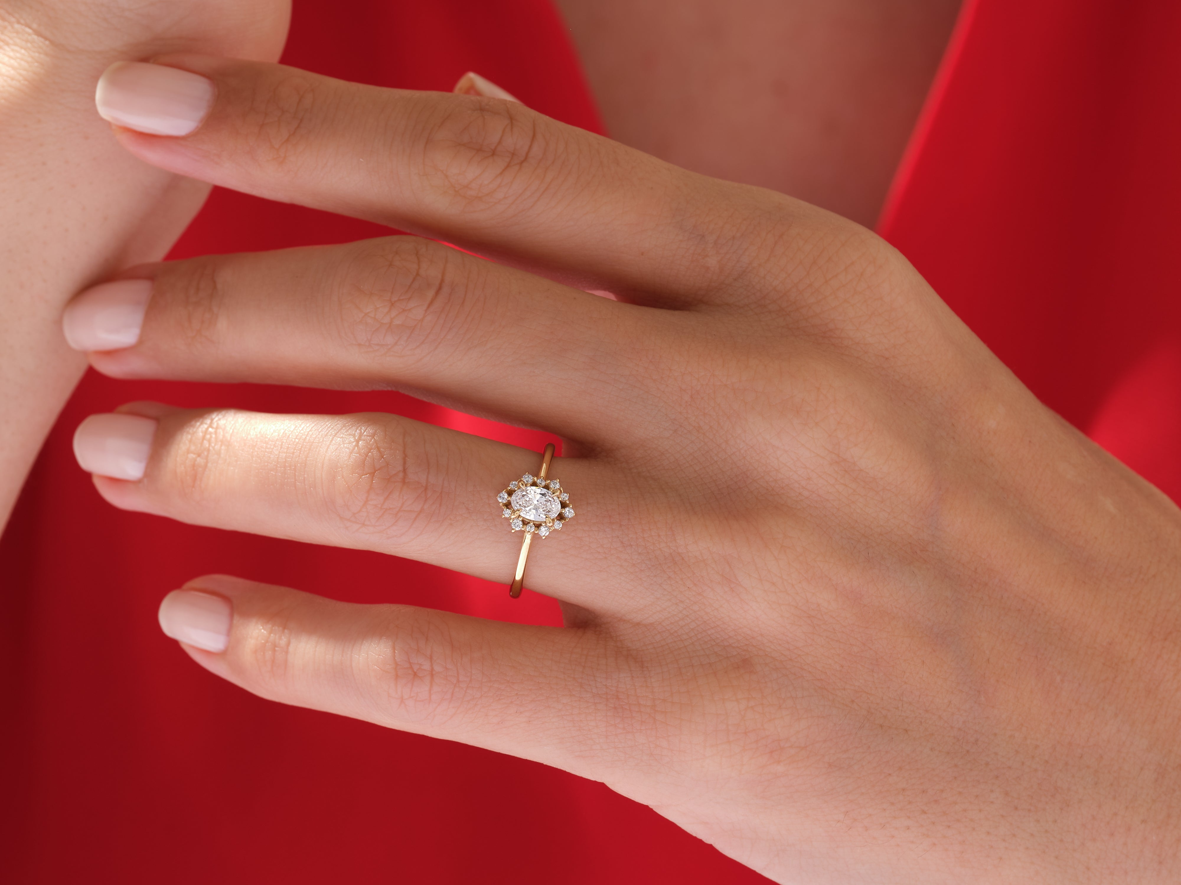 Oval diamond halo ring on a woman's hand