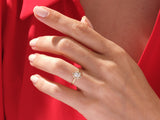 Gold oval diamond engagement ring on hand