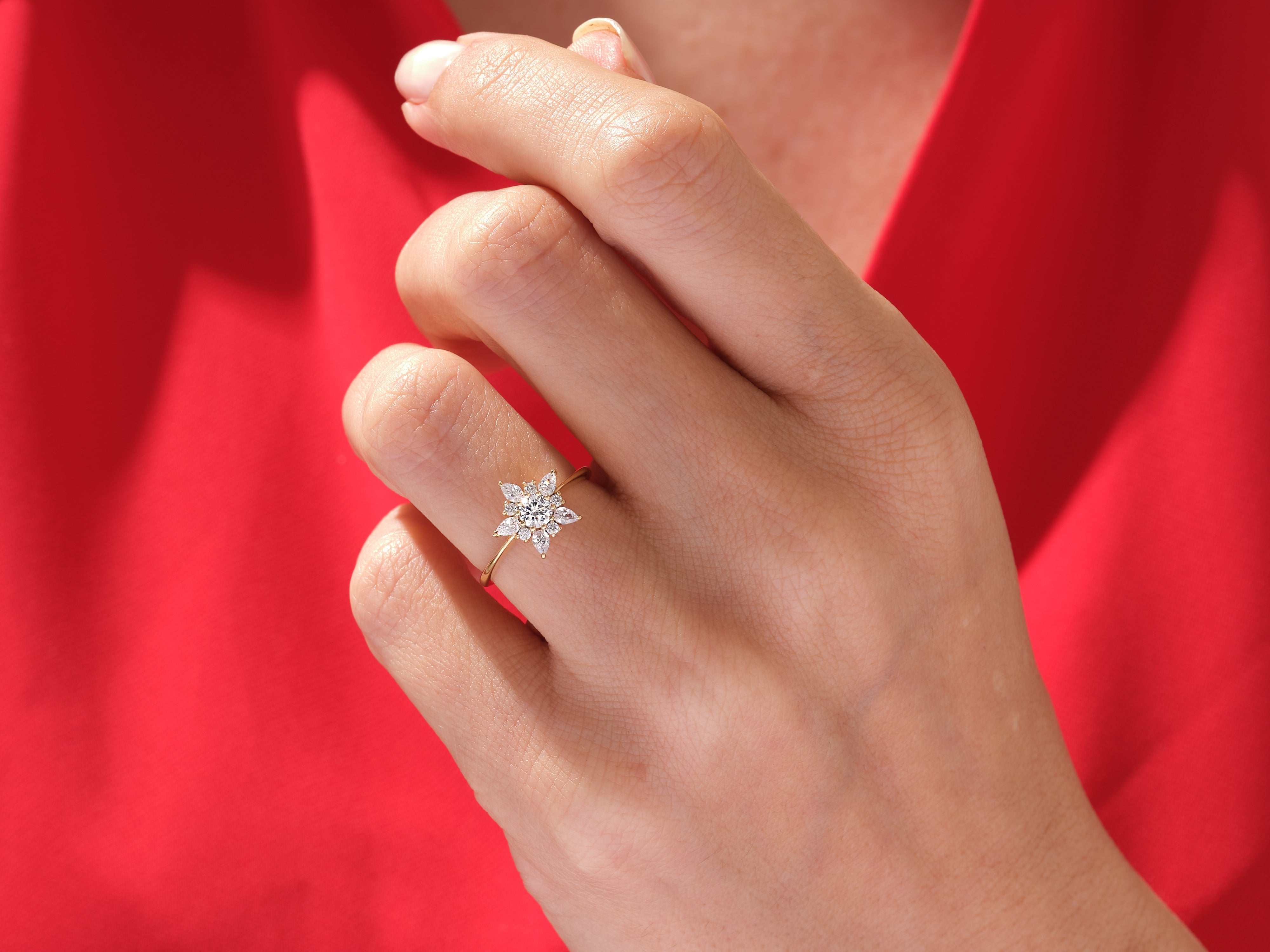 Gold diamond flower ring on hand