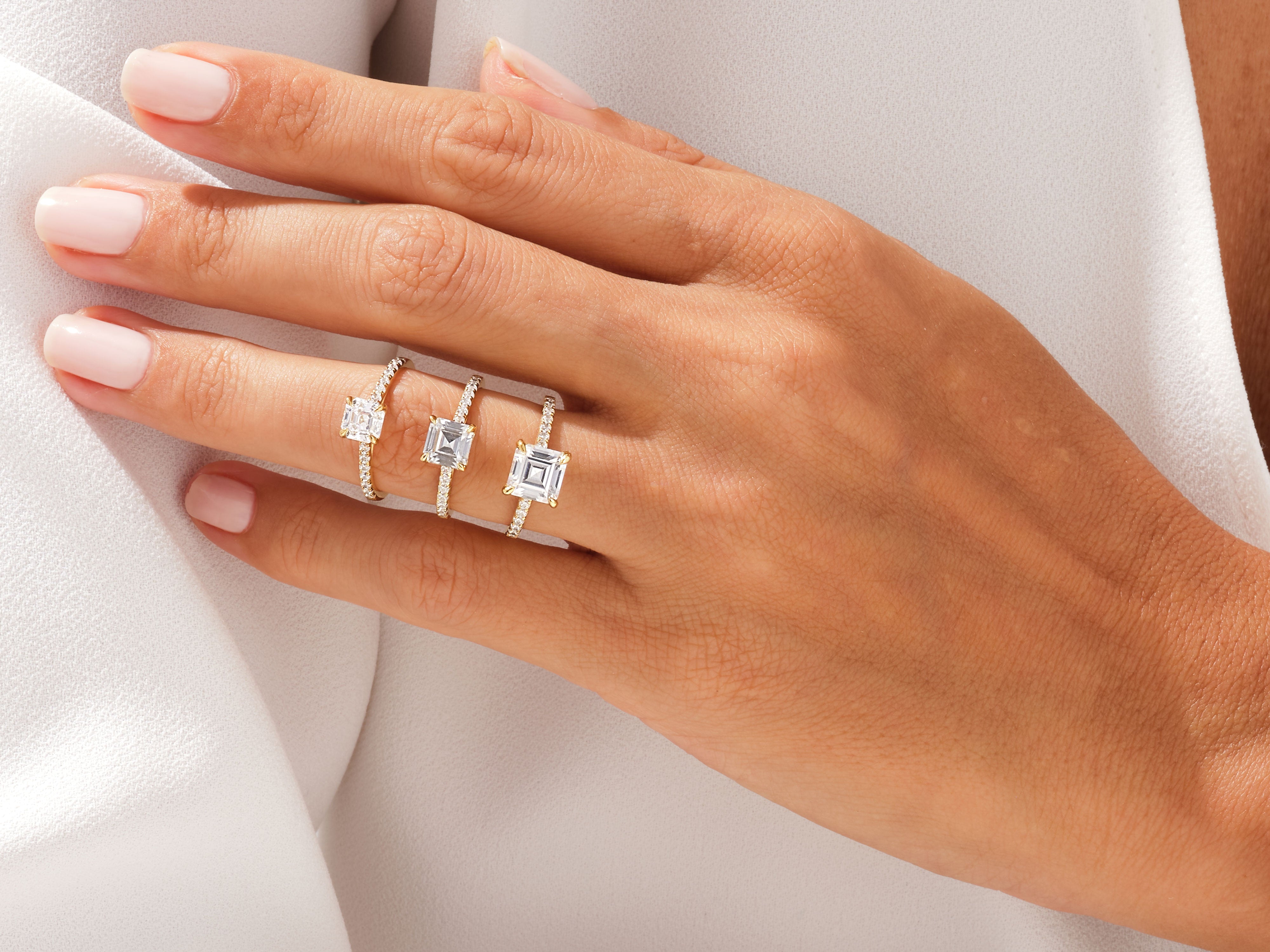 Diamond engagement rings on a hand, luxury jewelry collection
