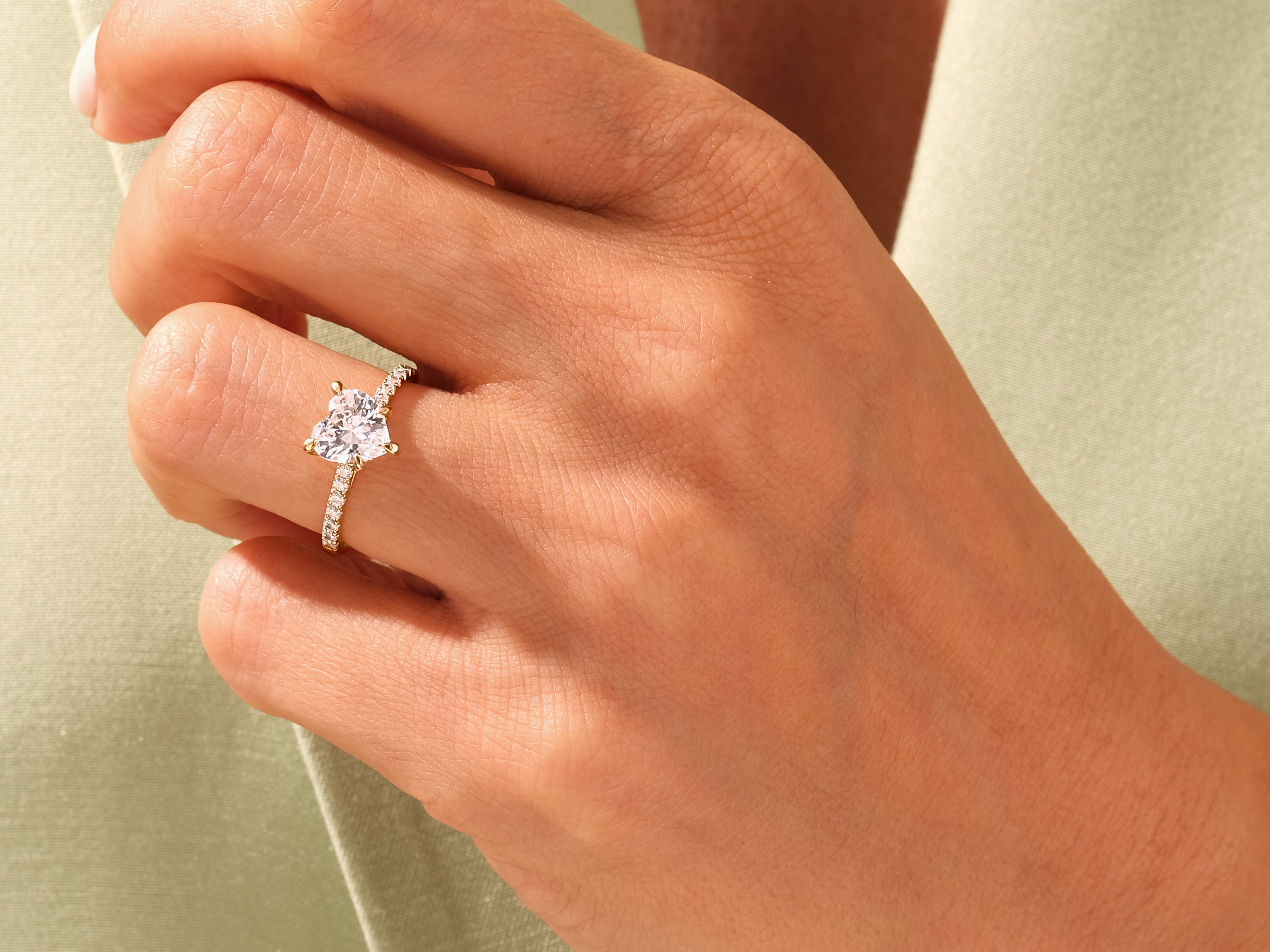 Heart-shaped diamond ring on a woman's hand, jewelry