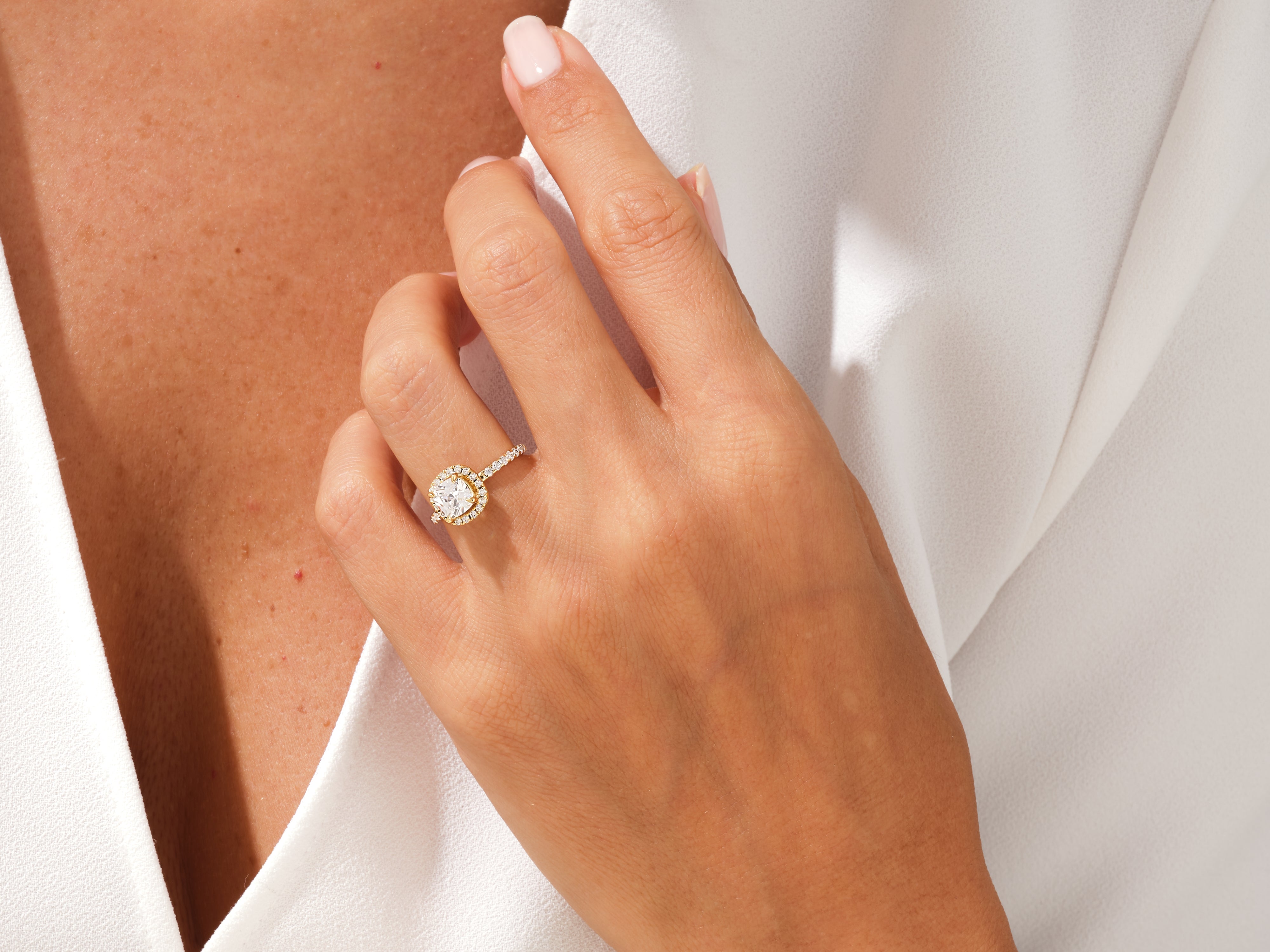 Diamond halo engagement ring on a woman's hand