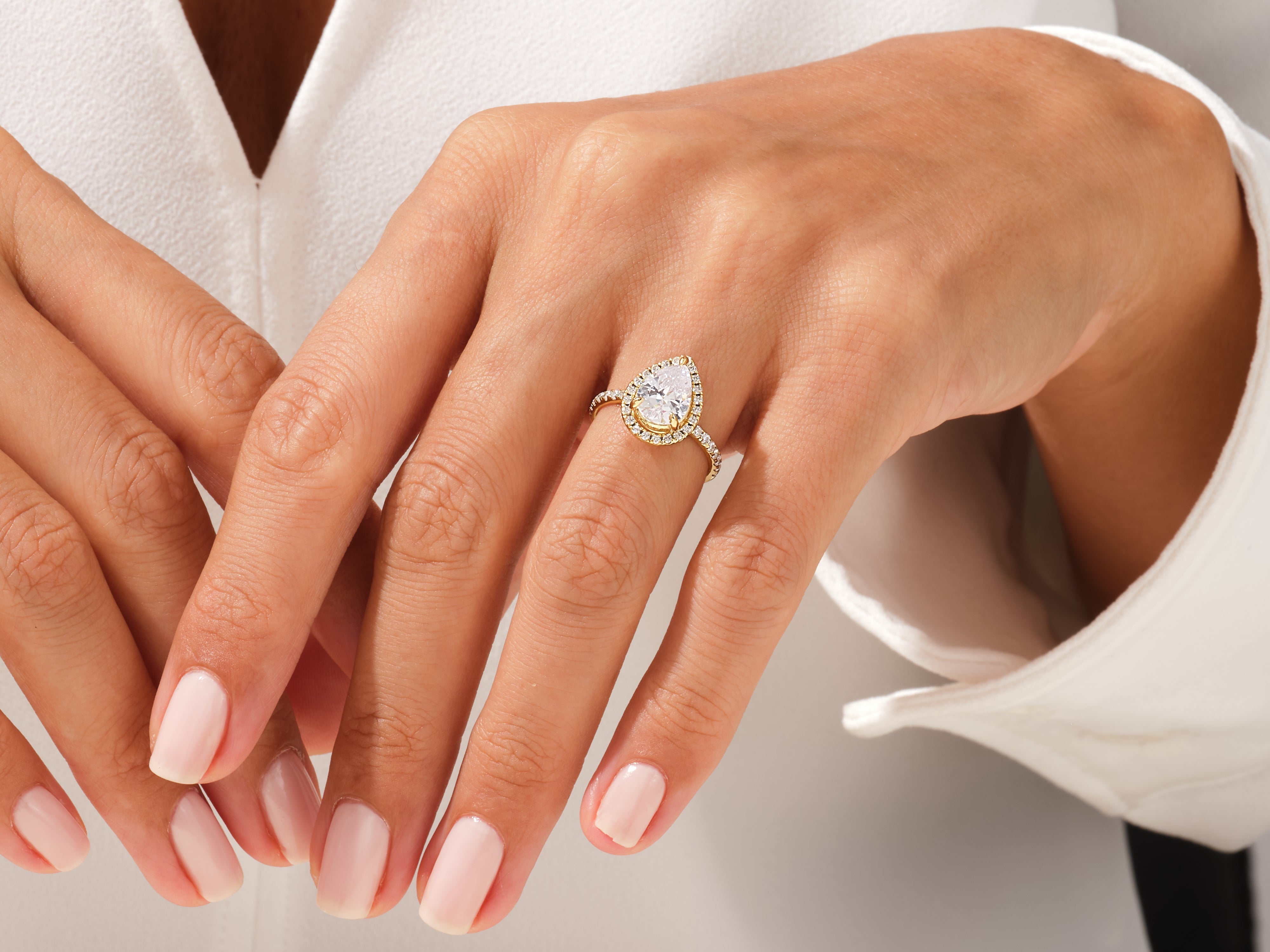 Pear-shaped diamond engagement ring on a woman's hand