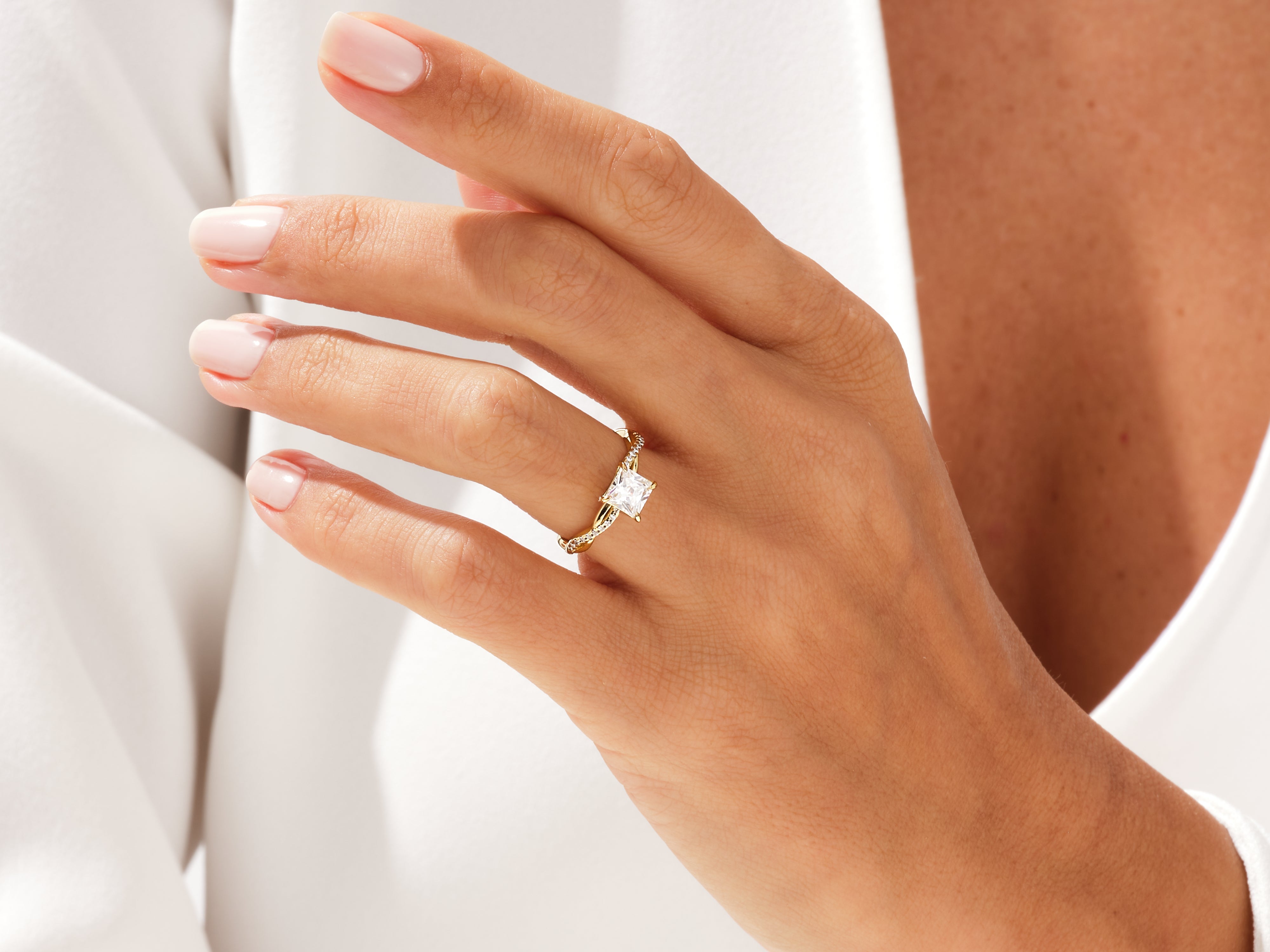 Gold diamond ring on a woman's hand, jewelry product