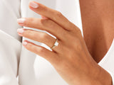 Gold diamond ring on a woman's hand, jewelry product