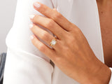 Gold princess cut diamond halo engagement ring on hand