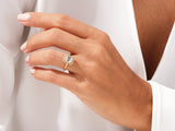 Emerald cut diamond halo ring on a woman's hand