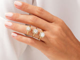 Gold diamond halo rings on a hand