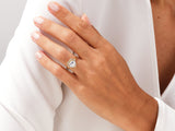 Gold heart engagement ring with diamonds on a woman's hand
