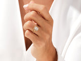 Gold emerald cut diamond halo ring on hand
