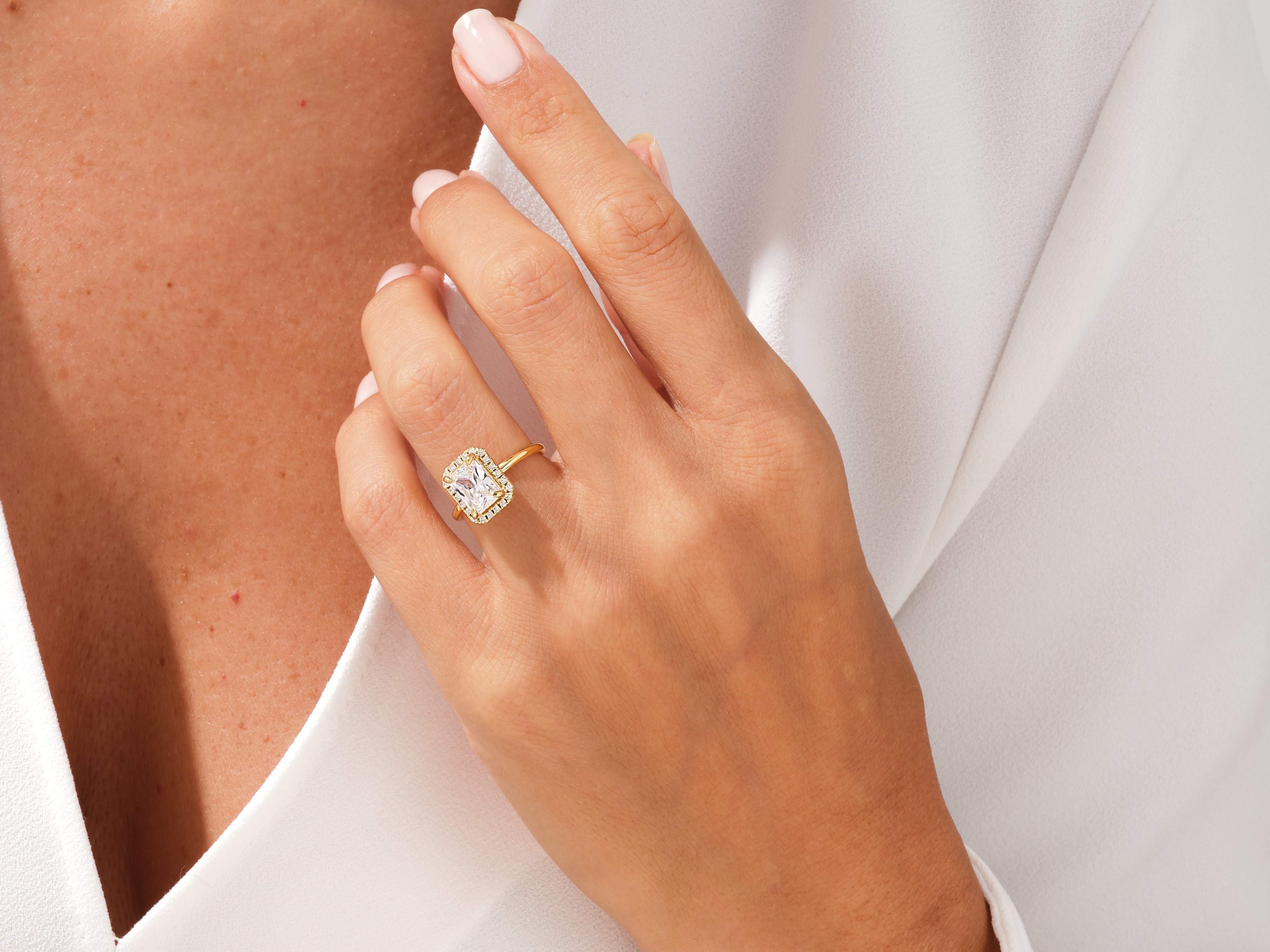 Gold halo engagement ring with radiant cut diamond
