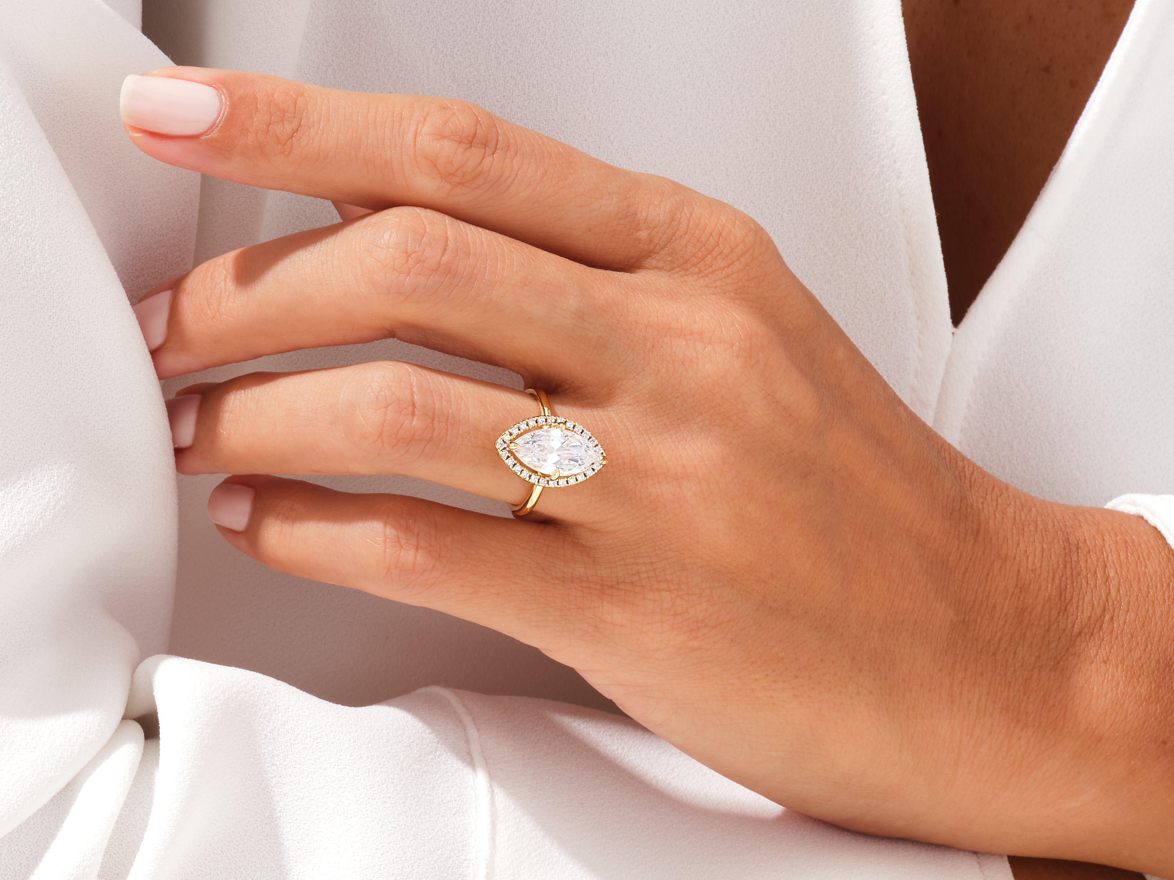 Marquise diamond engagement ring with halo, gold band