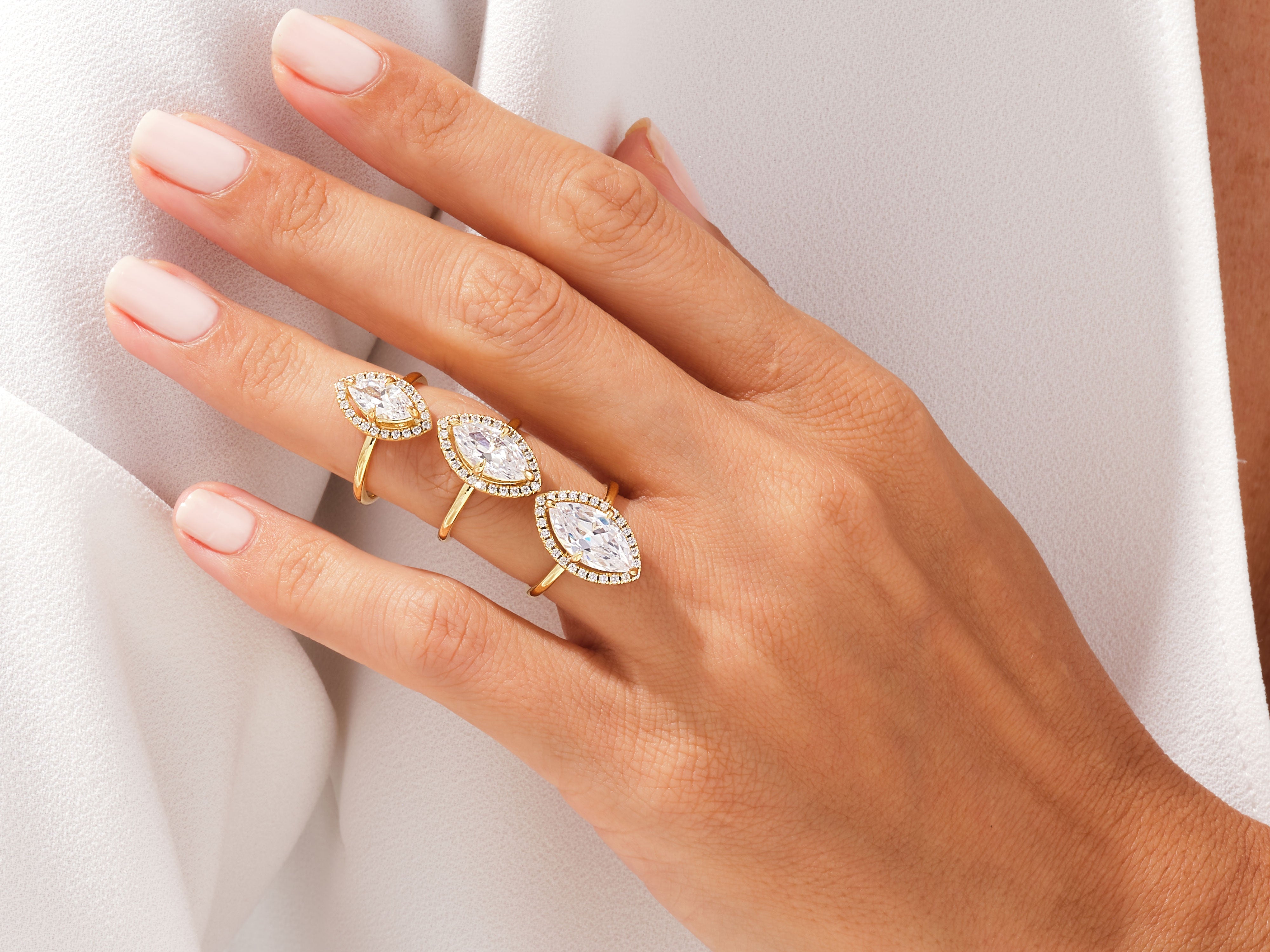 Gold marquise diamond rings with halo, jewelry photography