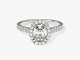 Oval diamond halo engagement ring with pave band