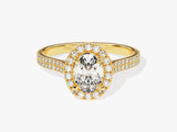 Gold oval diamond halo engagement ring with pave band