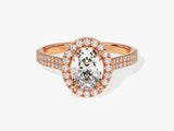 Oval diamond engagement ring with rose gold band and halo