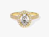 Oval diamond halo engagement ring in yellow gold