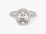 Oval diamond halo engagement ring with pave band