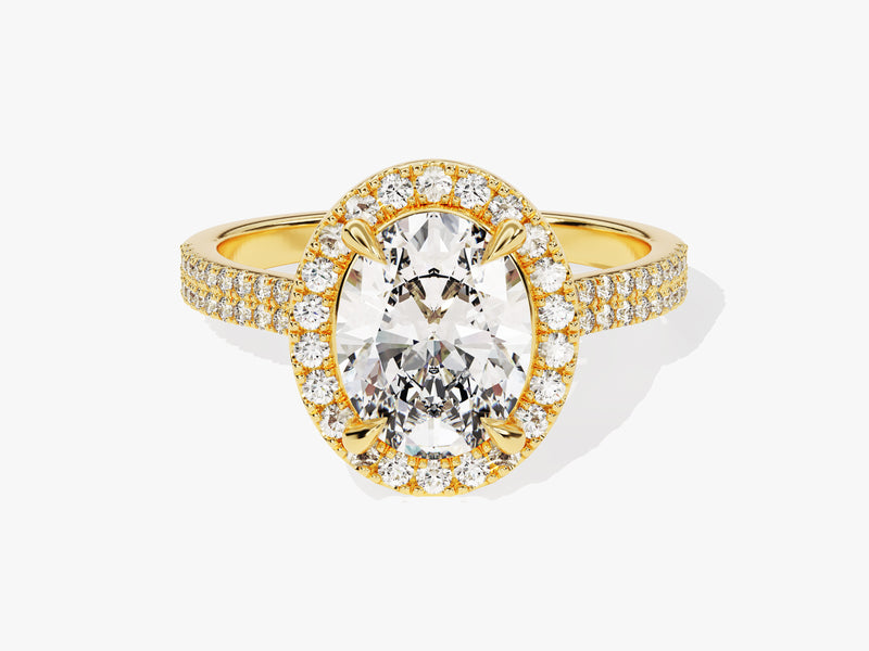 Oval diamond halo engagement ring in yellow gold