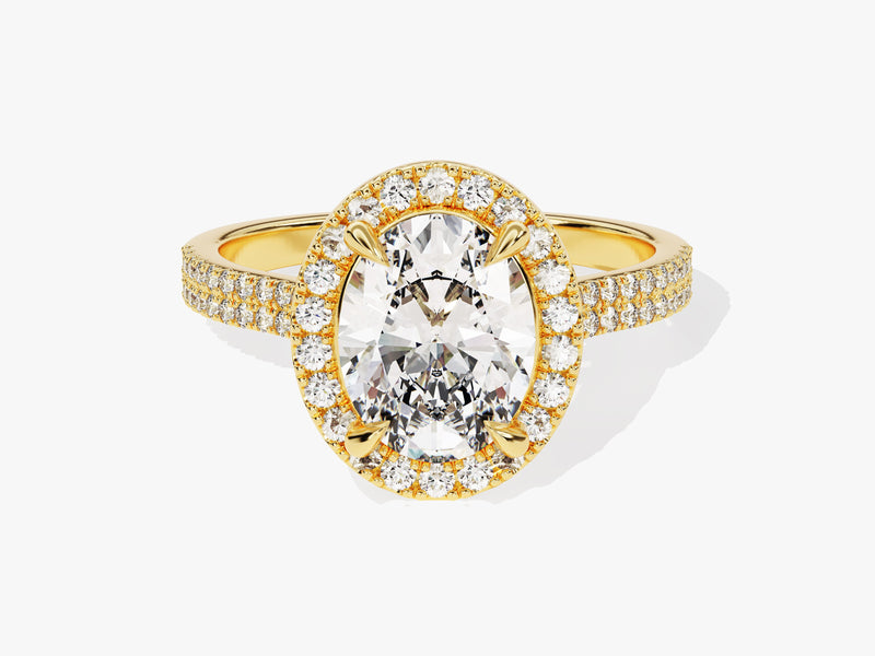 Oval diamond halo engagement ring in yellow gold