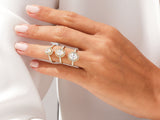 Three diamond halo rings on a hand, jewelry collection