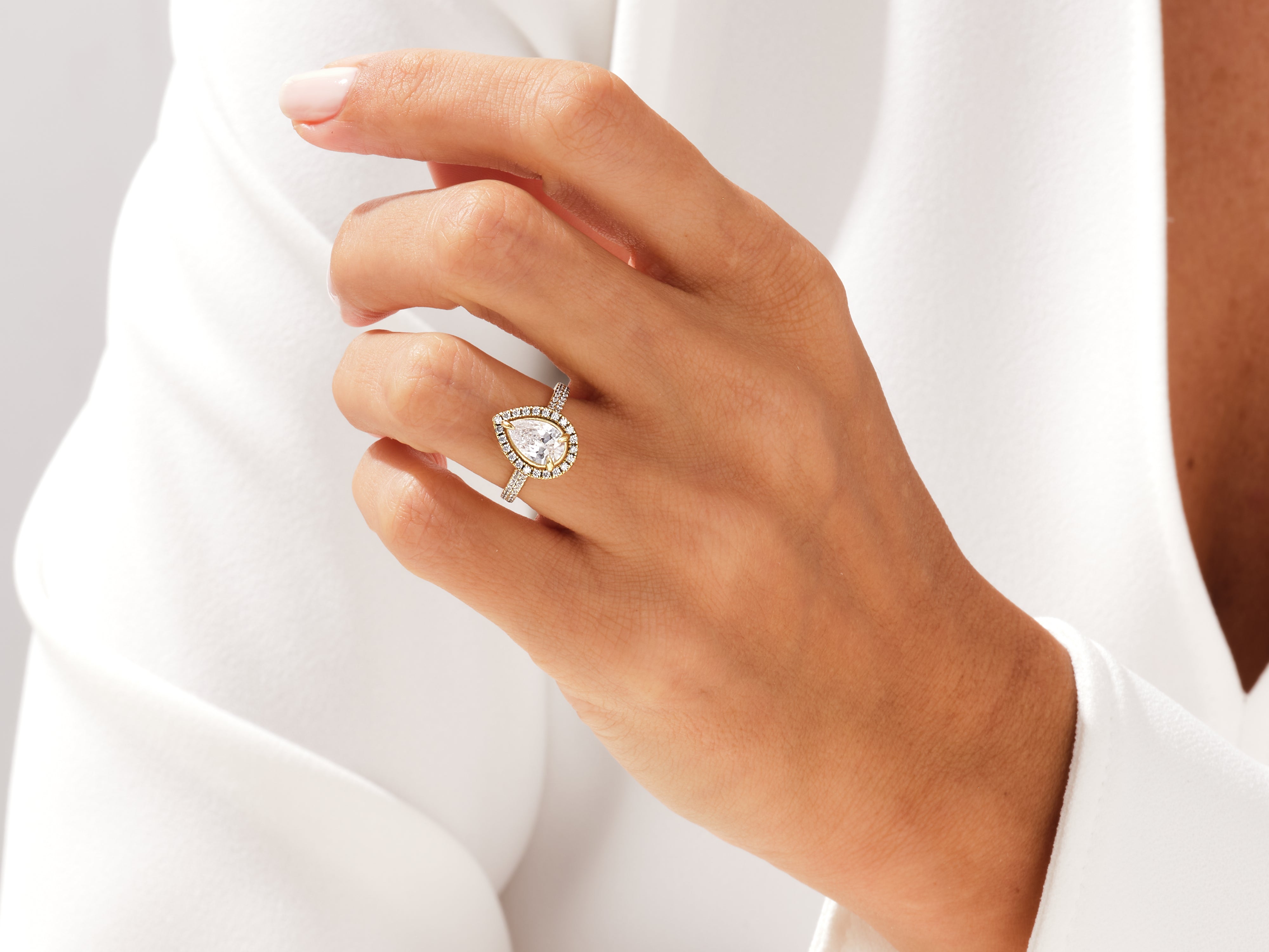 Pear-shaped diamond engagement ring with halo, jewelry firm product