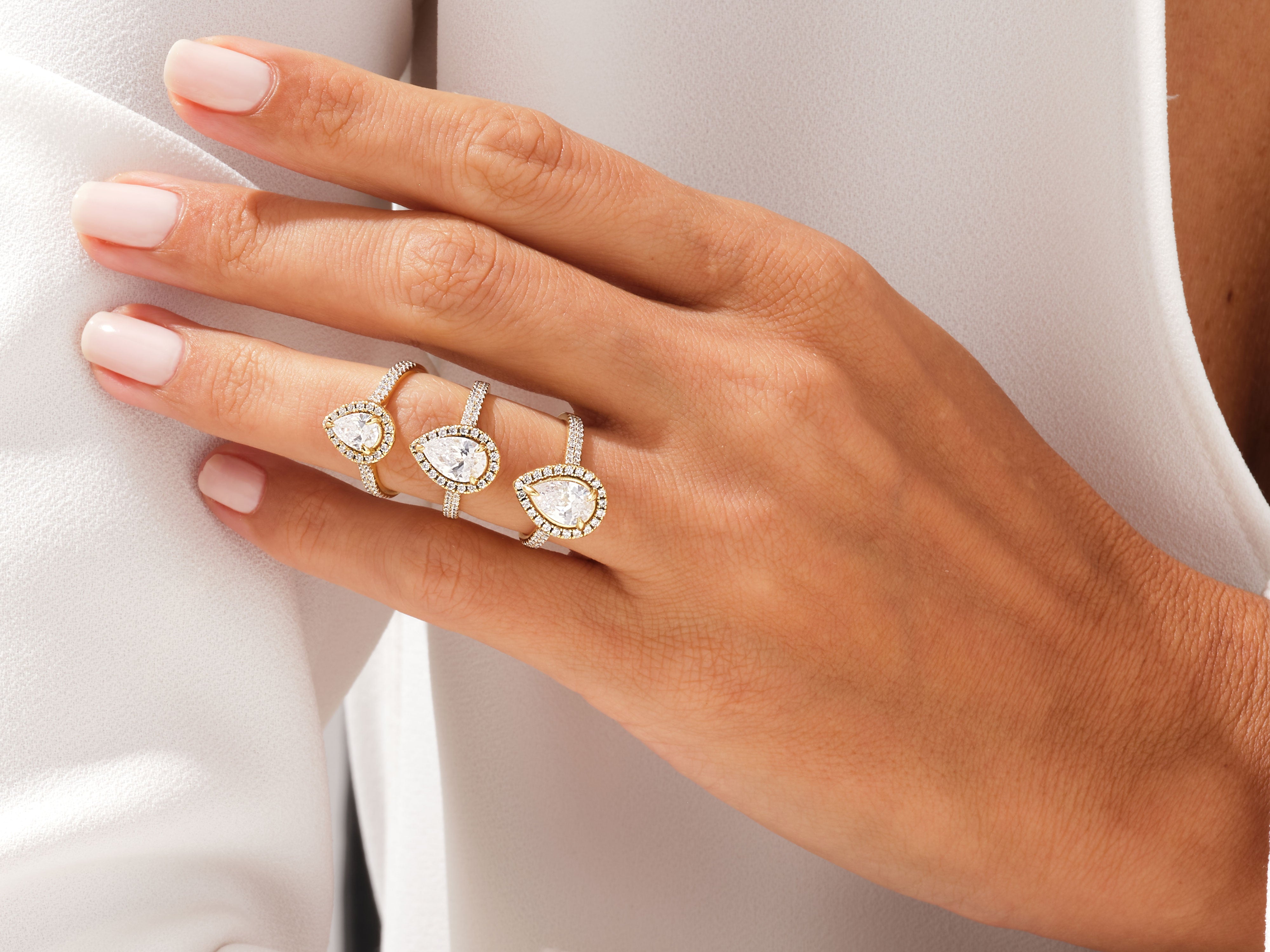 Diamond pear cut rings on a hand, jewelry collection
