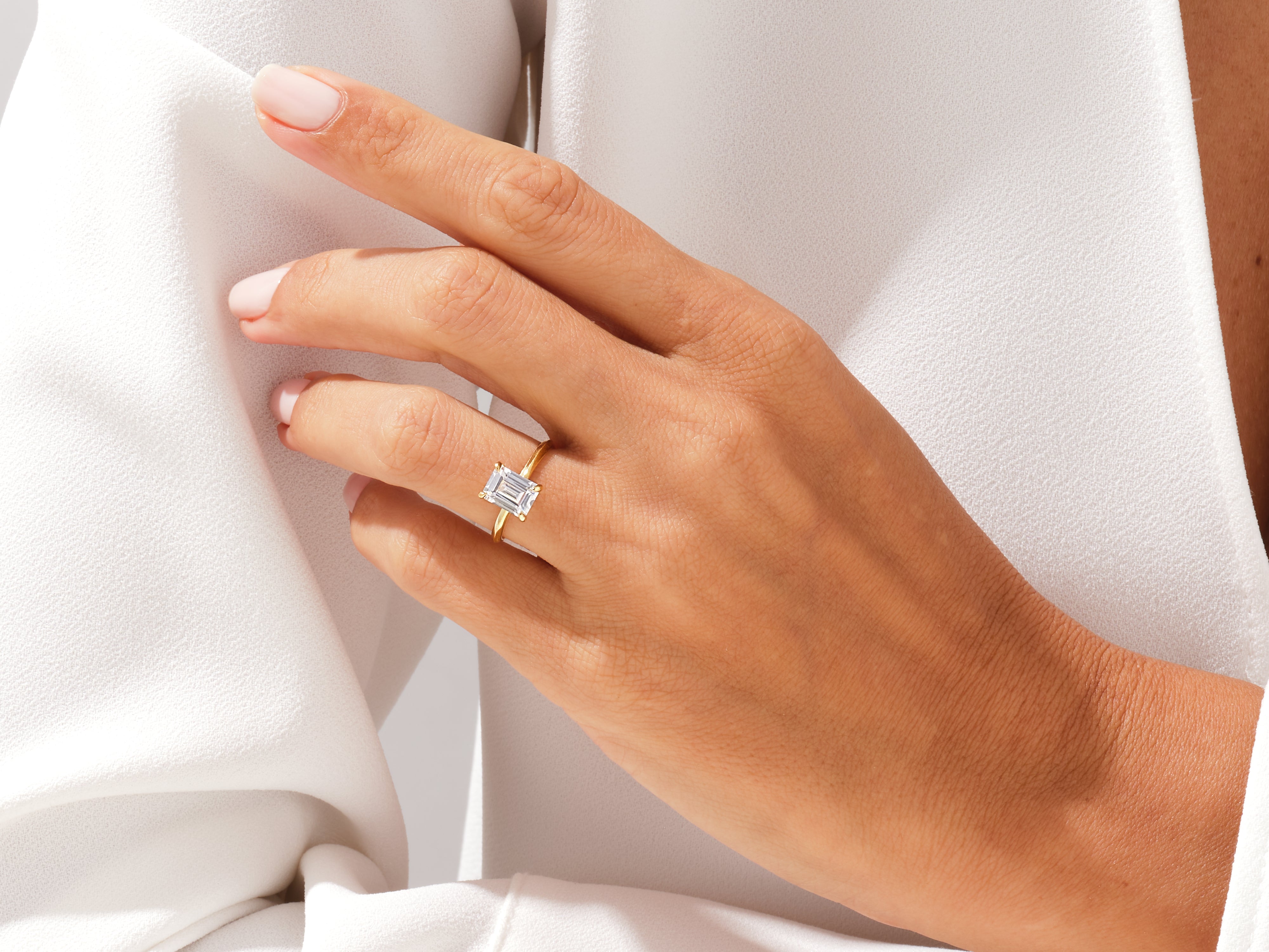 Emerald cut diamond ring on a hand, fine jewelry