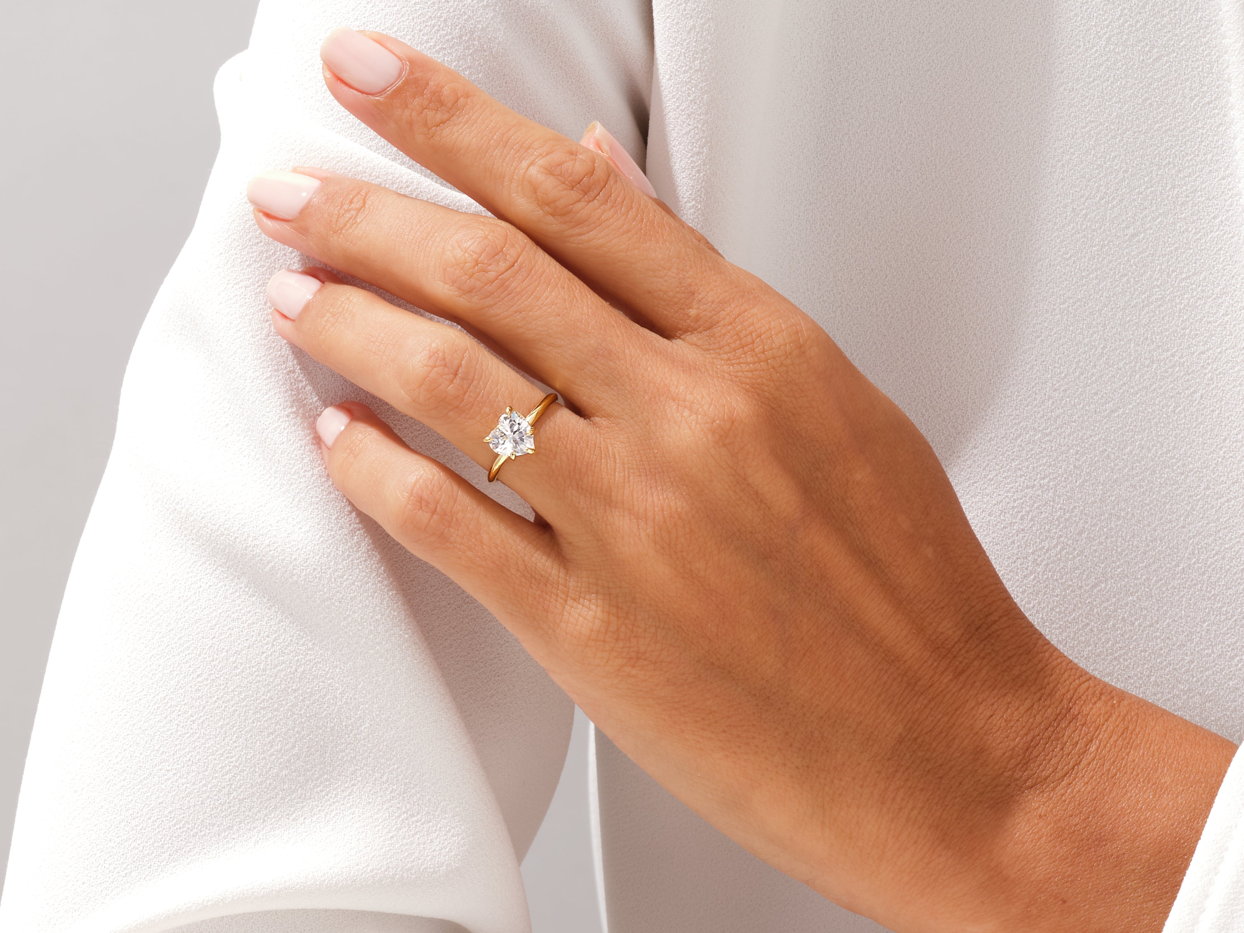 Gold heart diamond ring on a woman's hand