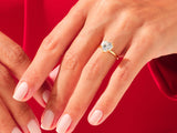 Heart-shaped diamond engagement ring on a woman's hand