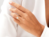 Gold ring with emerald cut diamond on a woman's hand