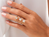 Gold rings with square cut diamonds on a hand