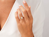 Gold pear-shaped diamond ring on a woman's hand