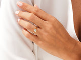 Gold ring with emerald cut diamond on hand