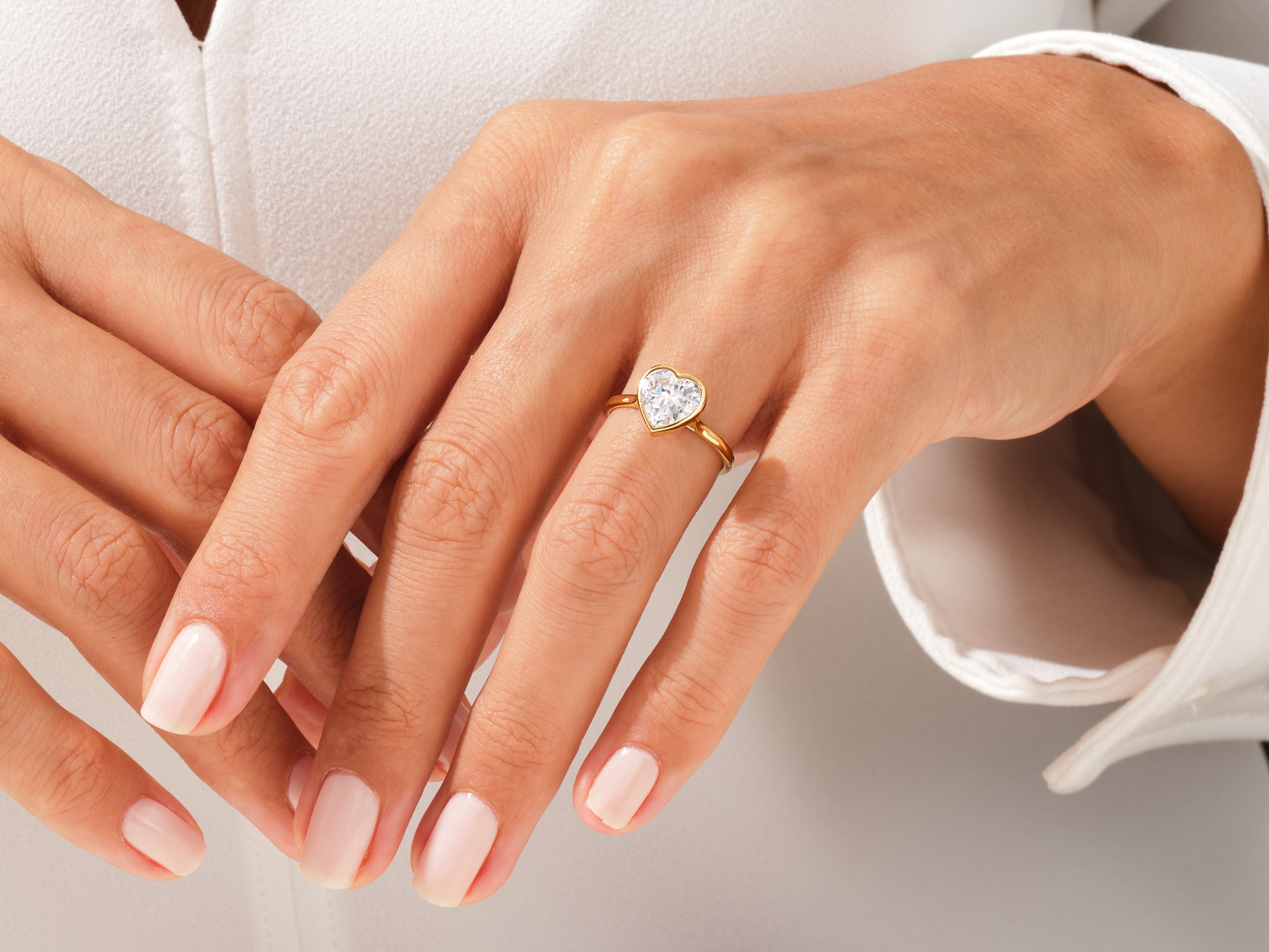 Gold heart diamond ring on a woman's hand