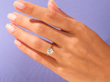 Gold heart ring with diamond on a hand