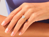 Heart-shaped diamond ring on a woman's finger, jewelry